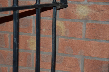 metal fence and brick wall