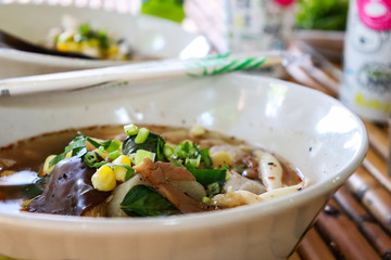 Spicy lemongrass flavored flat noodles with mushroom.