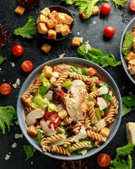 Caesar Salad Pasta with chicken, tomato, parmesan cheese and vegetables