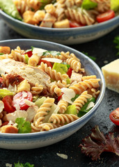 Caesar Salad Pasta with chicken, tomato, parmesan cheese and vegetables