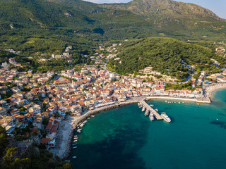 Fototapeta na wymiar Parga Greece drone aerial view. Crystal water natural landscape and beautiful architectural buildings near the port of Parga Epirus, Greece, Europe.
