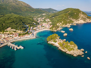 Parga Greece drone aerial view. Crystal water natural landscape and beautiful architectural buildings near the port of Parga Epirus, Greece, Europe.
