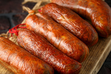 traditional Balearic raw cured meat sobrassada sausage made from ground pork, paprika and spices on rustic black background