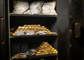 Bank vault with gold and cash