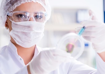 Female scientist researcher conducting an experiment in a labora