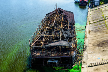 Old burnt cruise ship near the bank of river dnieper in Kiev, Ukraine
