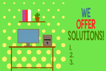 Conceptual hand writing showing We Offer Solutions. Concept meaning way to solve problem or deal with difficult situation Desktop computer with wooden table shelf books flower pot