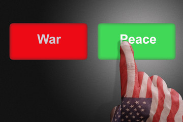 Hand with the colors of the American flag chooses the peace button