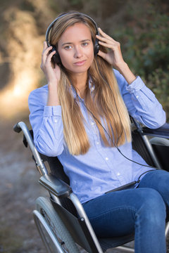 disabled young woman in wheelchair outdoors in rural scene