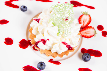 Tartlet with cream decorated with berry fruit