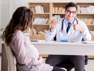 Fototapeta premium Pregnant woman visiting doctor for consultation