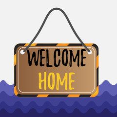 Conceptual hand writing showing Welcome Home. Concept meaning Expression Greetings New Owners Domicile Doormat Entry Board attach string color black yellow frame rectangle shape