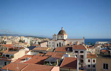 Obraz premium view of Alghero, city of Sardinia, with the Mediterranean sea and the hills in the background