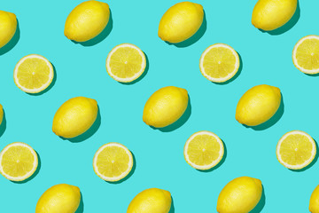 Colorful fruit pattern of fresh lemon and lemon slices on colored background. Lemon slices top view, flat lay