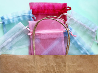 Organza bags and recycled eco bag on blue background. Organza bags can be used for storage...