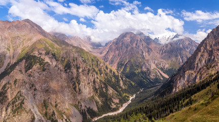 Fototapeta premium Panoramic view of the beautiful Left Talgar mountain valley with river, rocks and forest in Tian Shan mountains near Almaty city; best place for active lifestyle, hiking and trekking in Kazakhstan.
