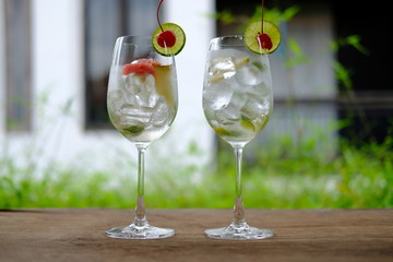 glass of gin with tonic water on wooden table
