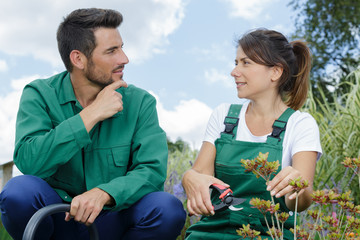 young gardening couple using secateurs