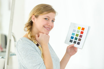 pretty girl holding a color swatch and smiling