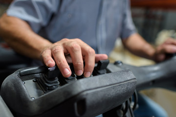 close up of factory heavy equipment hands operator
