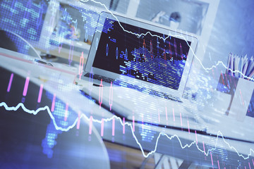 Stock market graph and table with computer background. Multi exposure. Concept of financial analysis.