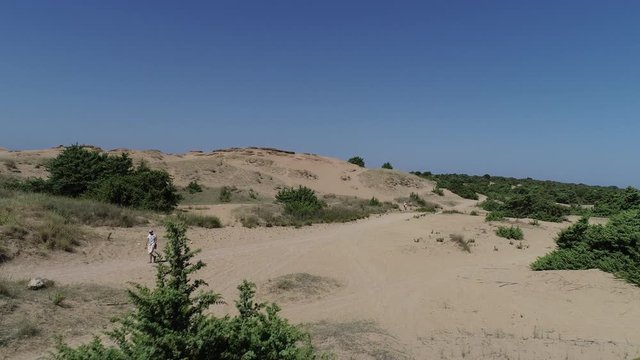 Aerial view of sand dunes and people are walking near beach in Greece Beach Issos Corfu