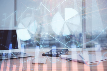 Forex graph hologram on table with computer background. Multi exposure. Concept of financial markets.