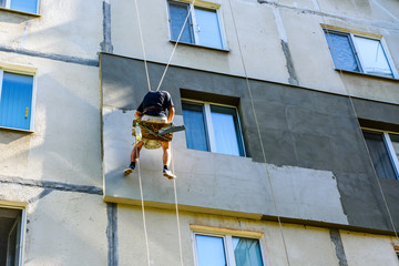 Insulation of apartments in a residential building. Rope access working