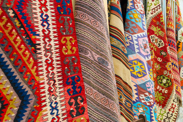 Different traditional turkish carpets hanging on a wall on a street in old town Kaleichi, Antalya,...