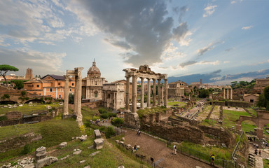 Image of Roman Forum in Rome, Italy during sunset in sunny day. View of Roman Forum with the Temple of Saturn and Vespasian, Rome, Italy.  Roman Forum is one of the main travel destinations in Europe.