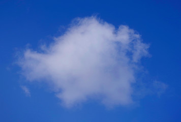 White round cloud against blue sky.
