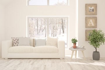 Stylish room in white color with sofa and winter landscape in window. Scandinavian interior design. 3D illustration