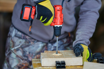 Man using drilling machine on wood