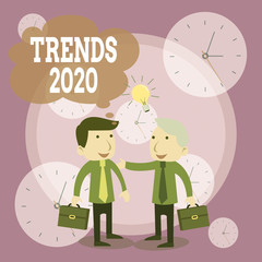 Conceptual hand writing showing Trends 2020. Concept meaning Upcoming year prevailing tendency Widely Discussed Online Businessmen Colleagues with Brief Case Sharing Idea Solution