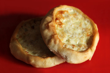 Round pastry with mushroom filling on red background
