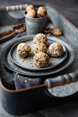 Dark chocolate truffle coated in chopped and toasted walnuts on a plate