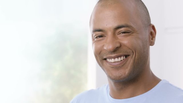 Mature man turning his head and smiling towards the camera