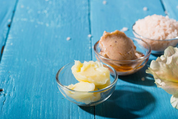 beauty product samples on old blue wooden table