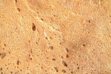 texture: golden crust of bread close up - food background