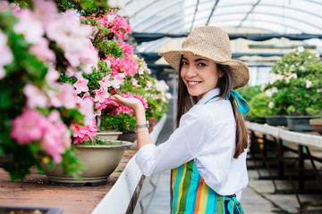 Beautiful woman working in a greenhouse