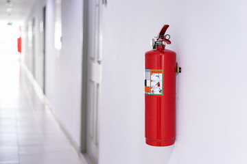 Fototapeta premium Fire extinguisher on wall in building