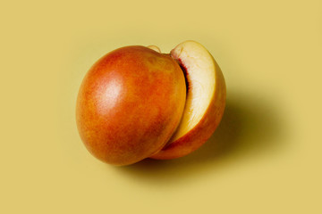 Nectarine, peach on a yellow background. copy space