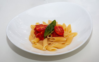 Italian pasta with tomato sauce and basil
