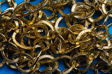 golden chain on a blue background. copy space one