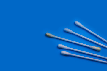 dirty cotton bud for ears on a blue background. copy space