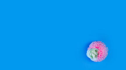 artificial flowers on a blue background frame for text. copy space