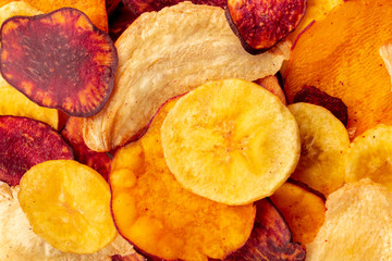 A close-up of dry fruit and vegetable chips, healthy vegan snack, a tasty mix