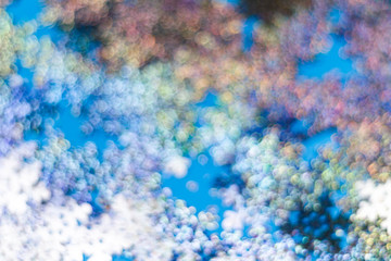 Snowflakes blur bokeh on a blue background. copy space