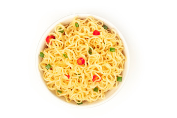 Soba noodles on a white background with red peppers and green onions, shot from the top
