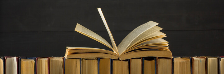 Open book, hardback books on wooden table. Back to school. Copy space